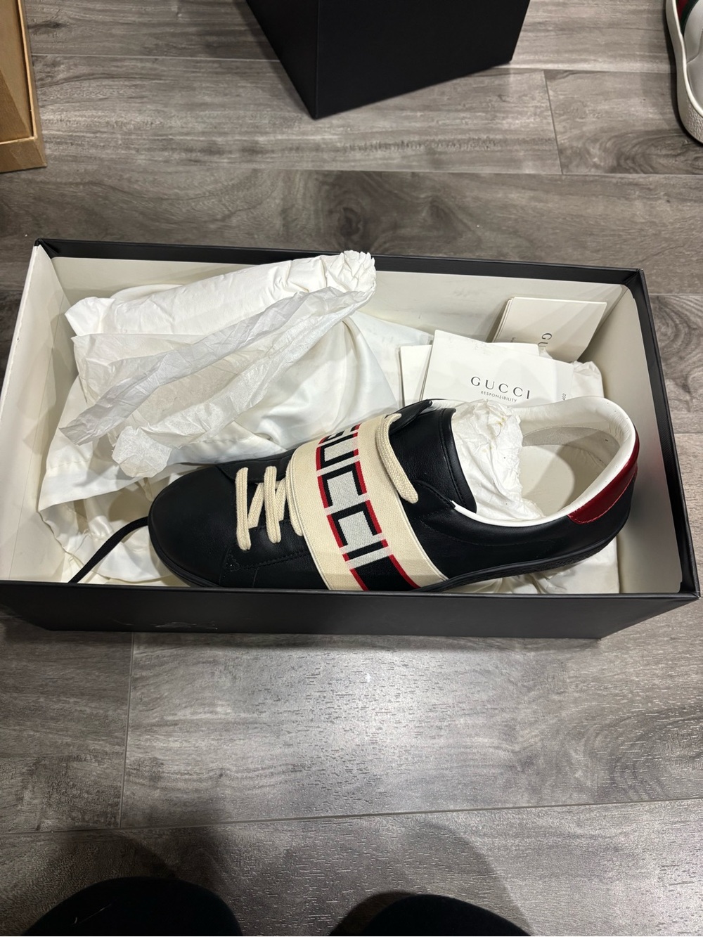 Gucci Men’s Black Leather Sneaker with White Logo Strap and Red Heel